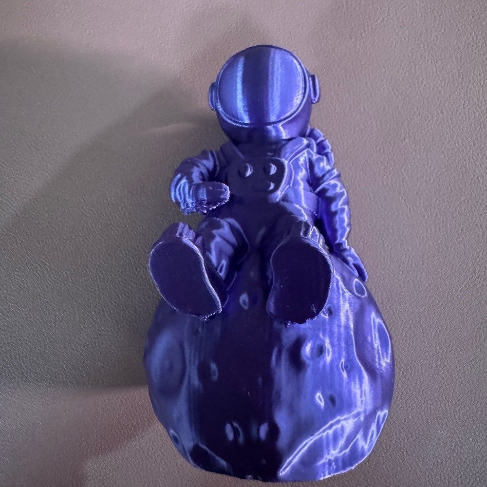 Metallic Purple Astronaut Figurine on Moon Base